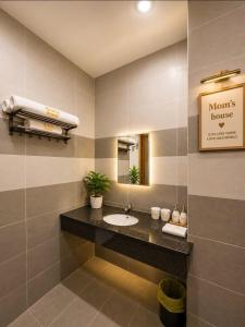 a bathroom with a sink and a mirror at Mom's house Lý Sơn in An Vĩnh Phướng