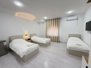 a hotel room with two beds and a window at CMC Hotel Apartment in Samarkand +45 photos