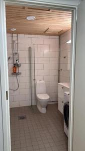 a bathroom with a toilet and a washing machine at Marina in Tampere