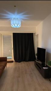 a living room with a stage with a black curtain at Marina in Tampere