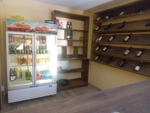a refrigerator filled with lots of bottles of wine at Otam-Check Guest House in Ondangwa