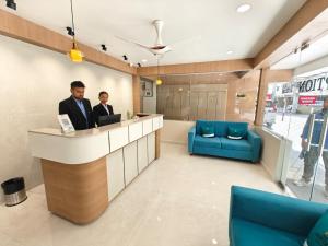 two men sitting at a counter in a waiting room at The Aspire Hotel Guwahati in Guwahati