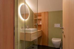 a bathroom with a sink and a toilet at Ferienwohnung Loipenblick in Obergesteln
