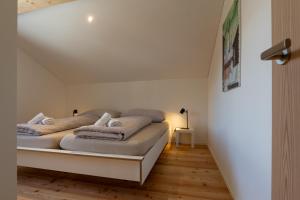 a bed with pillows on it in a room at Ferienwohnung Loipenblick in Obergesteln