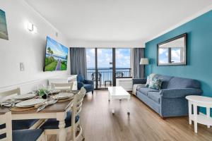 a living room with a table and a couch at Condos at the Caribbean Resort in Myrtle Beach +85 photos