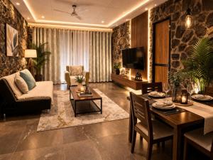 a living room with a dining table and a living room with at Enliven Homestay Alibag, Alibaug in Nagaon