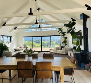 a living room with a table and chairs at Views on King in Egmont Village