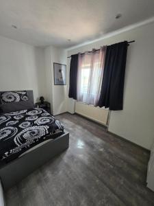 a bedroom with a bed and a window at Marien 2 Ferienwohnung Monteuerwohnung in Eppelborn +2 photos