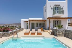a villa with a swimming pool and a house at Philippi Villa in Mikonos