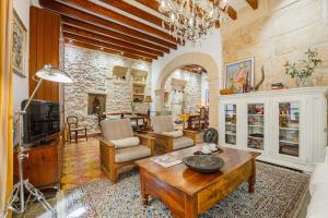 a living room with a couch and a table at Casa Angels in Pollença +31 photos