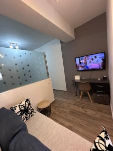a living room with a couch and a flat screen tv at Kova2 in Alexandroupoli