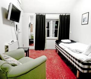 a living room with two beds and a couch at Meteorologen Ski Lodge in Riksgränsen