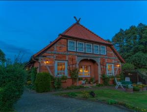 a large brick house with a gambrel roof at Steins Hof in Suderburg