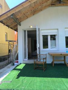 a patio with a wooden bench and a table at Summer Relax in Keramoti