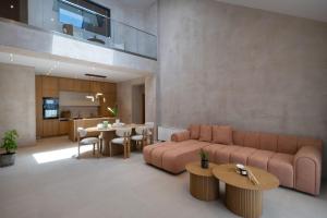 a living room with a couch and a table at Nomade Villas in Agios Ioannis Peristerion