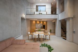 a living room and dining room with a table and chairs at Nomade Villas in Agios Ioannis Peristerion