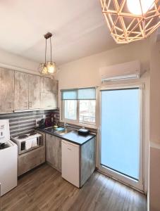 a kitchen with a large window in the middle at Kova2 in Alexandroupoli