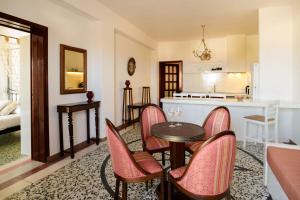 a kitchen and living room with a table and chairs at Kaminia Holiday Homes in Éxo Goniá