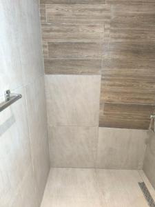 a bathroom with a shower with a tiled shower at Summer Relax in Keramoti