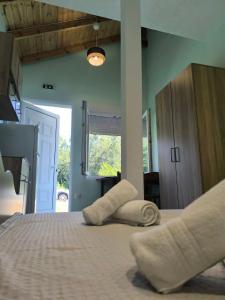 a bedroom with a bed with two pillows on it at Summer Relax in Keramoti