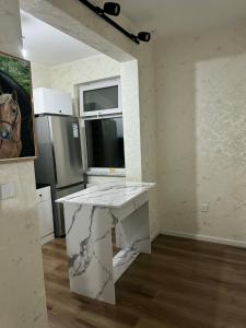 a kitchen with a marble counter top in a room at Sunrise Guesthouse UB in Ulaanbaatar +8 photos