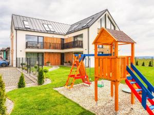 a playground in front of a house at GERALT Tatras Residence in Nová Lesná