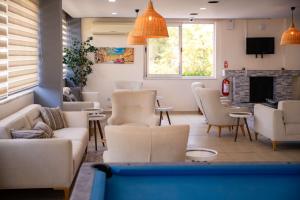 a living room with couches and chairs and a fireplace at Nora Suit Hotel in Side