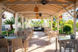 an outdoor restaurant with tables and chairs and awning at Nora Suit Hotel in Side