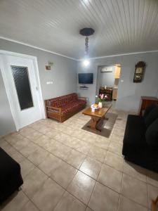 a living room with a couch and a table at Papadopoulos House in Kavála
