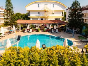 a swimming pool in front of a building at Nora Suit Hotel in Side