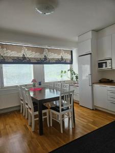 a kitchen and dining room with a table and chairs at Apartment Asemakatu 20 in Kuopio