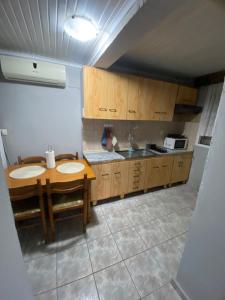 a kitchen with two sinks and a table at Papadopoulos House in Kavála
