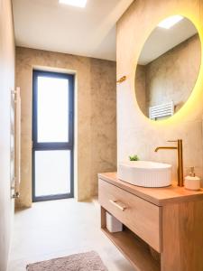 a bathroom with a sink and a mirror at GERALT Tatras Residence in Nová Lesná +28 photos