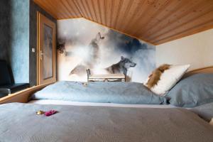 a bedroom with a bed with a painting of wolves at Ferienhaus Fanny in Lam