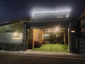 a house with a lawn in front of it at night at 湖山沐旅 Hu Shan Mulu in Douliu