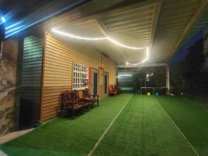 a patio with green grass and lights on a house at 湖山沐旅 Hu Shan Mulu in Douliu +4 photos
