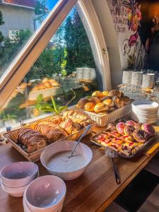 a table with many different types of bread and pastries at Zöldház Panzió in Gyenesdiás