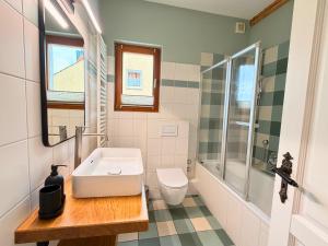 a bathroom with a sink and a toilet and a shower at Lilla Villa - Pá stranden - in Kellenhusen +39 photos