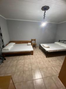 a room with two beds and a light on the ceiling at Papadopoulos House in Kavála