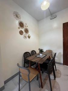a dining room with a wooden table and chairs at Baldonado Transient Homestay in San Isidro +3 photos