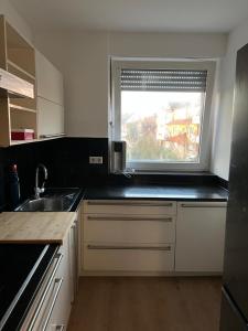 a small kitchen with a sink and a window at Avansunterkünfte für Monteure in Hamm
