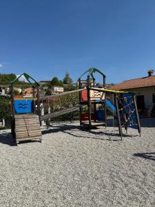 a playground with two swings and a slide at Hiša 88 in Dutovlje