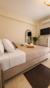 a bedroom with a large bed with a large mirror at Idene Penthouse in Chania
