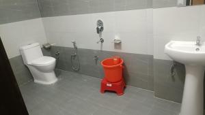 a bathroom with a toilet and a sink at Hotel Turi & Punjabi Restaurant in Rewalsar