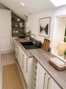 a kitchen with a sink and a counter at Ivy golf cottage in Leven