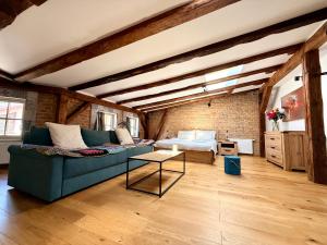 a living room with a couch and a table at Siesta by Rentoom in Toruń