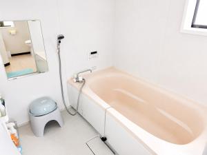 a white bathroom with a tub and a toilet at 宿のきむら2 in Utsunomiya +26 photos