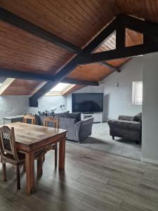 a living room with a table and a couch at Fairladies Barn Guest House in St Bees