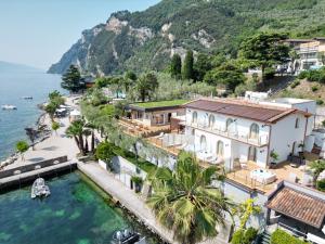 an aerial view of a house next to the water at Villa Helena in Limone sul Garda