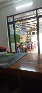 a table in a restaurant with people sitting at tables at Phong Nha Riverview Home in Phong Nha